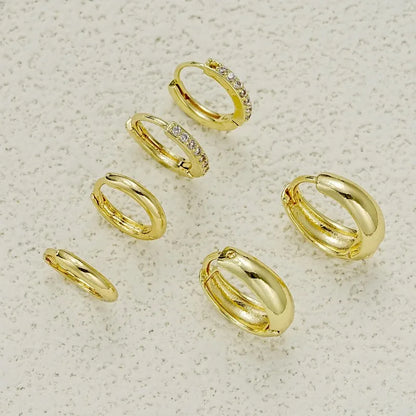 Three pairs of gold-plated stainless steel hoop earrings with crystal zirconia, ideal for women’s punk jewelry.