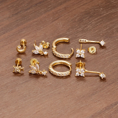 Four small hoop earrings set featuring star, moon, and flower designs in stainless steel by DoubleMfashion.