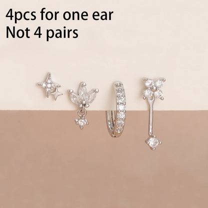 Set of 4 small hoop earrings featuring star, moon, and flower designs in stainless steel by DoubleMfashion.