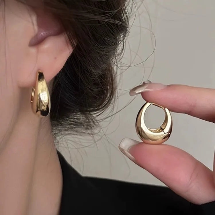 Three pairs of gold-plated stainless steel hoop earrings with crystal zirconia for women, featuring a trendy punk design.