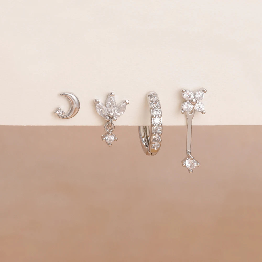 Set of 4 stainless steel small hoop earrings featuring star, moon, and flower designs for women by DoubleMfashion.