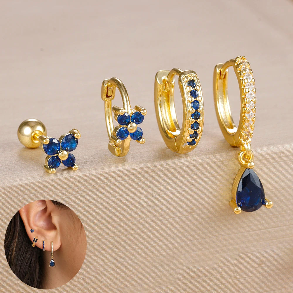 Set of 4 small hoop earrings featuring star, moon, and flower designs in stainless steel by DoubleMfashion.