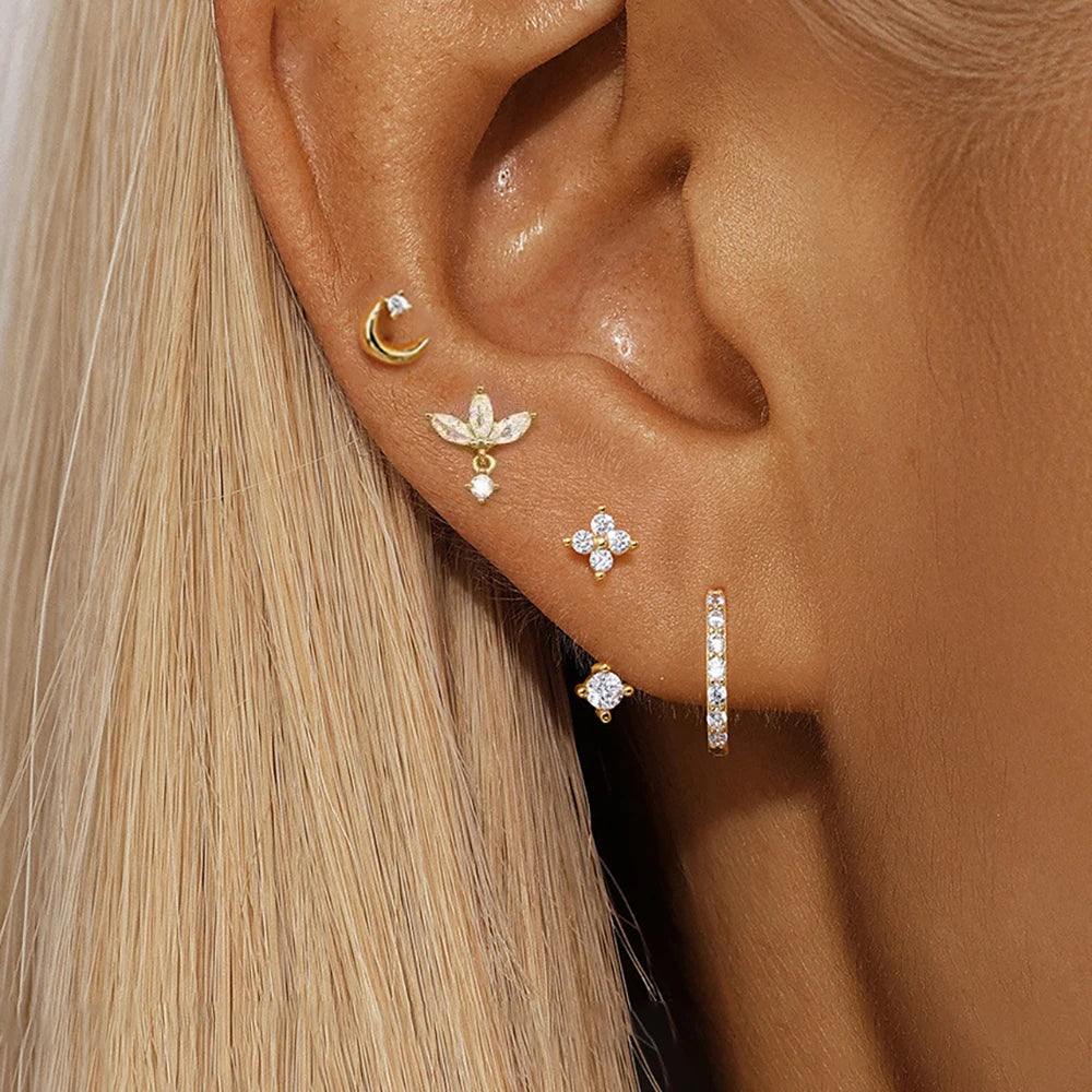 Set of 4 small hoop earrings featuring star, moon, and flower designs in stainless steel by DoubleMfashion.