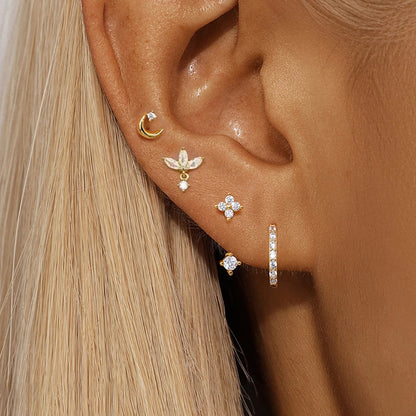 Set of 4 small hoop earrings featuring star, moon, and flower designs in stainless steel by DoubleMfashion.