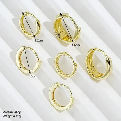 Three pairs of gold-plated hoop earrings with crystal zirconia by DoubleMfashion, showcasing a trendy, simple design.